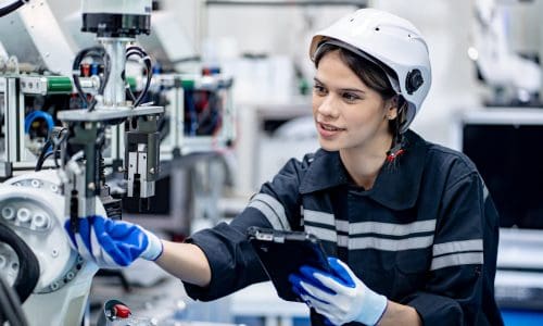 Modern industrial technology. Female Robotics engineer fitting sensors in robotics research facility