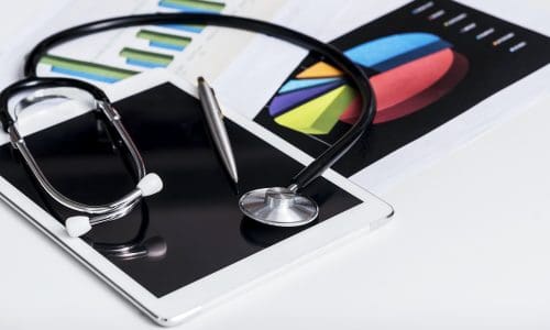 Healthcare and business concept. Stethoscope on tablet with report chart paper.