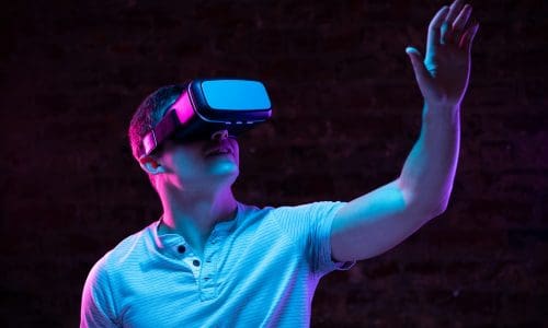 Caucasian man holding a Virtual Reality headset