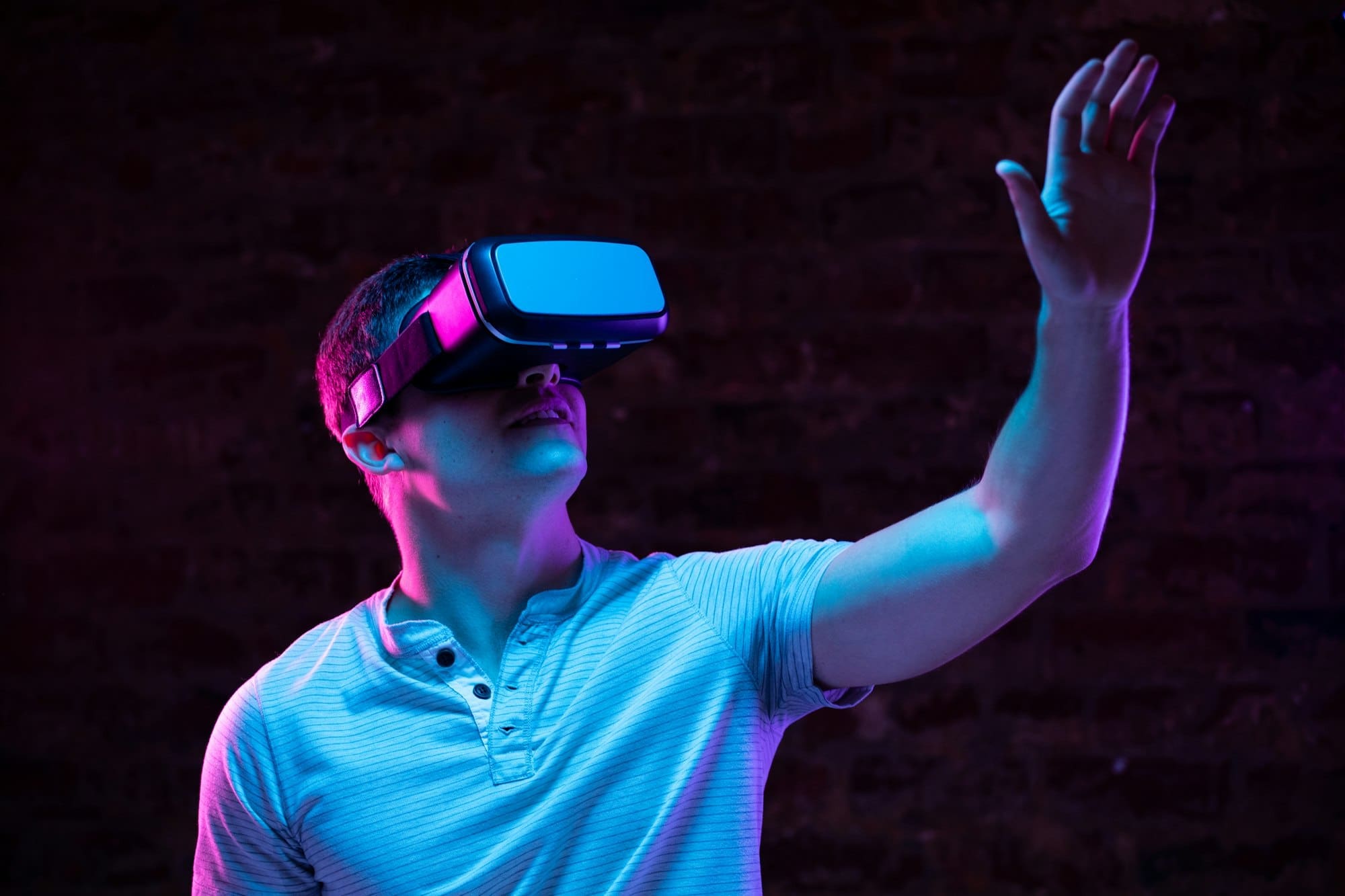 Caucasian man holding a Virtual Reality headset